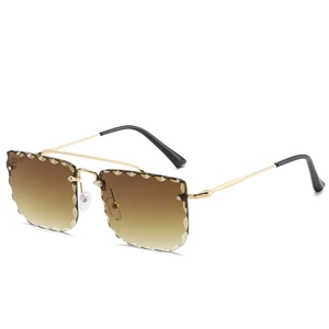 Frameless oversized sunglasses with gradient brown wave-cut lenses and gold metal frames