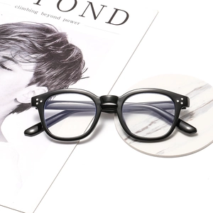 Lunettes anti-lumière bleue à monture noire classique avec rivets sur support marbre