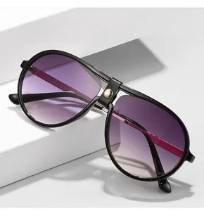 Close-up of pilot sunglasses with leather-wrapped bridge detail and purple gradient lenses