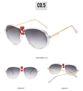 Detail view of aviator sunglasses with transparent frames and red leather bridge trim
