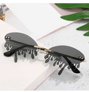Detail view of stylish sunglasses with unique grey teardrop lenses and gold metal bridge