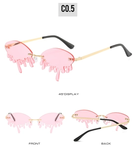 Detail of pink melting water drop sunglasses with golden frames and black temples
