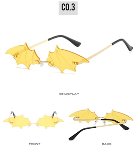 Three perspectives of bat wing shaped yellow sunglasses with gold metal frames