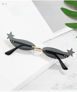 Detail of star-shaped sunglasses with black oval lenses and sleek golden metal frames