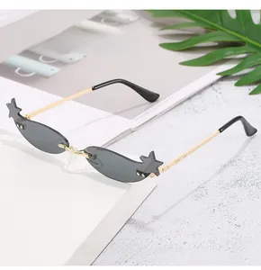 Detail of star-shaped accents on rimless sunglasses with dark grey tinted lenses
