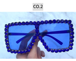 Detailed view of oversized square sunglasses featuring navy blue rhinestone embellished frames