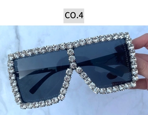 Close-up of oversized square sunglasses featuring premium round crystal embellishments