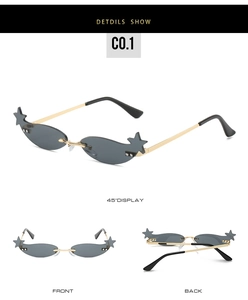 Detail view of star-shaped rimless sunglasses with gold metal frame and gray lenses