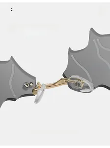 Close-up of bat sunglasses featuring gold metal bridge and soft clear nose pads