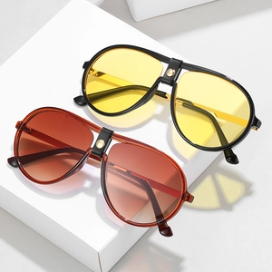 Fashion aviator sunglasses with gradient lenses and leather bridge detail on white pedestal
