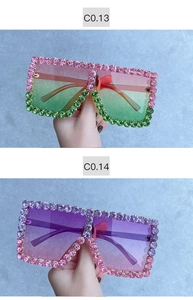 Detailed view of oversized square sunglasses with colorful rhinestones and gradient lenses