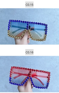 Detailed view of oversized square sunglasses with sparkling colorful rhinestones on frame