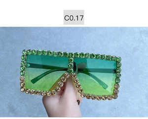 Detail of oversized square sunglasses with gradient rhinestones and tinted lenses