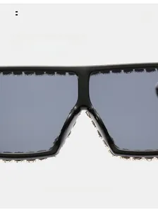 Close-up of comfortable nose pads and rhinestone trim on oversized black sunglasses