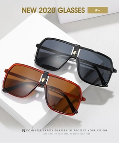 Close-up of oversized square sunglasses featuring black and tortoiseshell frames with metal details