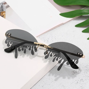 Fashionable rimless sunglasses with unique grey teardrop melting lenses and gold metal frame