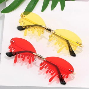 Fashionable rimless melting drop sunglasses in vibrant red and yellow with gold frames