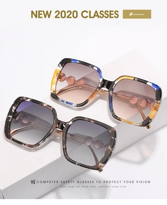 Detail of oversized square sunglasses with pearl beads on tortoise and marble frames