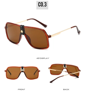 Detail view of large pilot sunglasses with dark orange frames and leather bridge trim