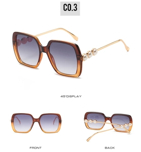Three-angle view of oversized amber sunglasses with gradient purple lenses and pearl detail