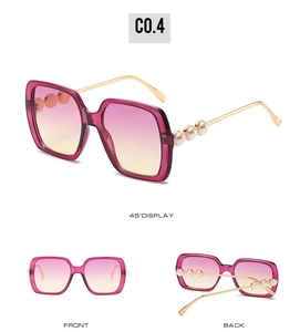 Detail view of square sunglasses featuring gradient lenses and pearl-studded gold temples