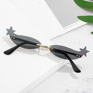 Star-shaped futuristic sunglasses with grey lenses and gold metal bridge on white props