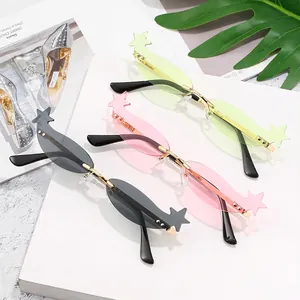Star-shaped rimless sunglasses in green, pink, and grey with gold metal frames