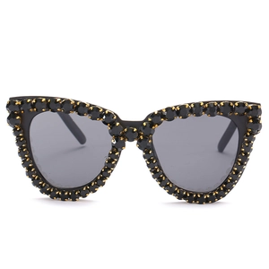 Fashion cat eye sunglasses with black rhinestones and gold metal claw settings
