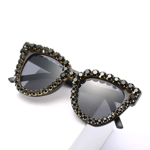 Vintage oversized sunglasses featuring black rhinestones and golden claw setting finish