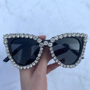 Fashionable cat eye sunglasses with rhinestones and black lenses for a party style look
