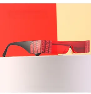 Detail of red shield sunglasses featuring wide temples with intricate snakeskin texture