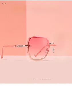 Close-up of pink gradient rimless sunglasses with textured silver metal temples