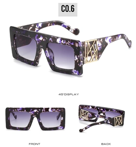 Detail view of purple marbled oversized sunglasses with gold geometric temple metal accents