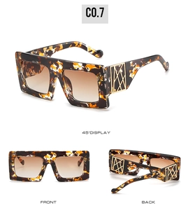 Detail view of tortoiseshell oversized sunglasses with gold hollow metal temple hinges