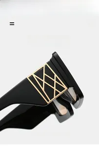 Detail view of high-quality oversized black sunglasses featuring golden geometric temple logos