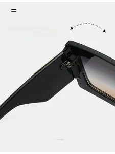 Detail of durable texture hinge and gold accents on black oversized sunglasses