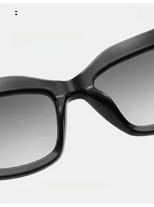 Detail of integrated nose pads on black cat-eye sunglasses with gradient lenses