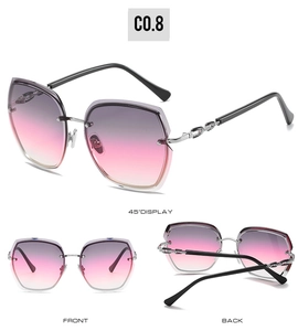 Detail view of rimless oversized sunglasses with purple gradient lenses and chain temples