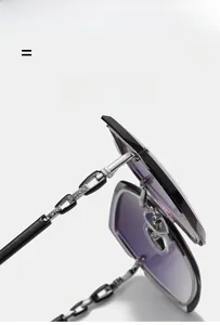 Detail of the rimless sunglasses featuring a metal chain temple with rhinestone accents