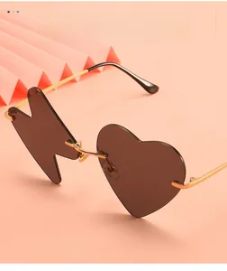 Detail of trendy asymmetrical sunglasses with heart and lightning shaped lenses