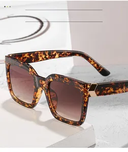 Detail of tortoise square sunglasses with brown gradient lenses and gold metal hinge