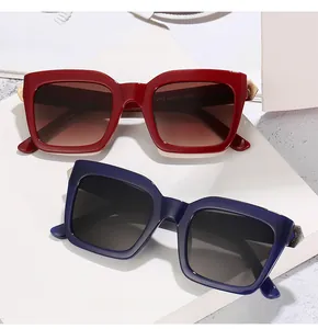 Detail of red and dark blue square sunglasses showing geometric metal hinges and hinges