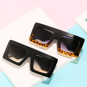 Oversized flat top square sunglasses with black and tortoise shell frames in gradient lenses