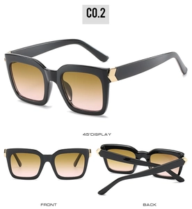 Detail of square sunglasses with classic black frames, gradient lenses and gold arrow hinges