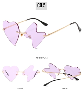 Detailed view of novelty purple rimless sunglasses with heart and lightning bolt lenses