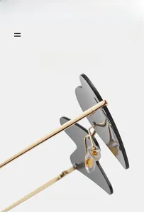 Detail view of heart-shaped sunglasses with golden metal frame and silicone nose pads