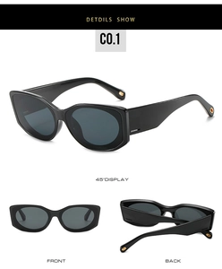 Détail de grandes lunettes de soleil carrées noires avec des accents métalliques dorés