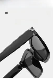 Close-up of black square sunglasses with silver V-shaped metal temple details