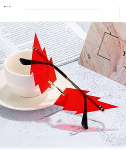 Close-up of red fire flame rimless sunglasses resting on a white cup with a modern background