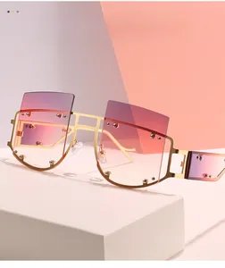 Detail of square alloy sunglasses with gold metal frame and pink gradient lenses